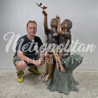 Boy & Girl Sitting on Stump with Monarch Butterflies Bronze Statue